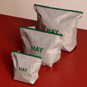 Candy Mono Wash Bag Set: Three stylish HAY wash bags in varying sizes, featuring a grid pattern and green zipper.