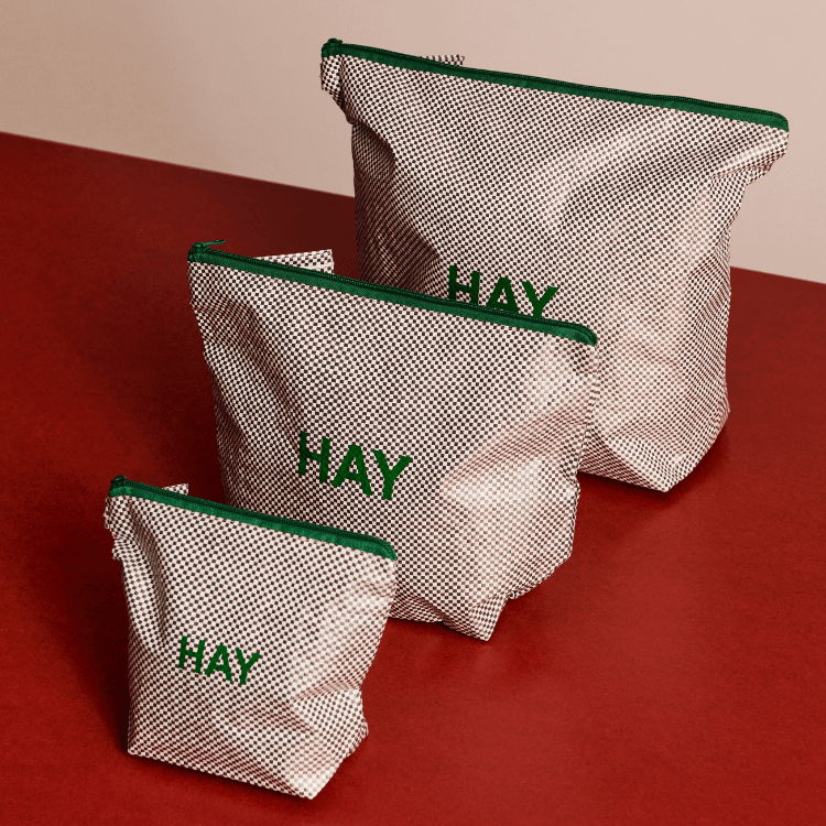 Candy Mono Wash Bag Set: Three stylish HAY wash bags in varying sizes, featuring a grid pattern and green zipper.