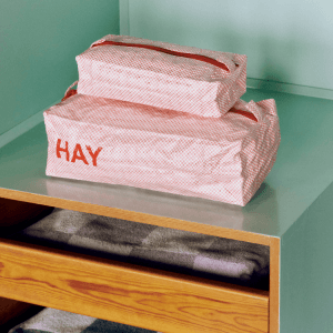 Candy Mono Wash Bag box set of 3 by HAY, pink checkered cosmetic bags with red zipper on a shelf.