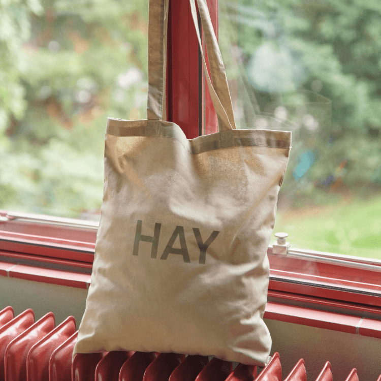 HAY Tote Bag: A stylish, reusable canvas bag with the HAY logo, perfect for shopping and everyday use.