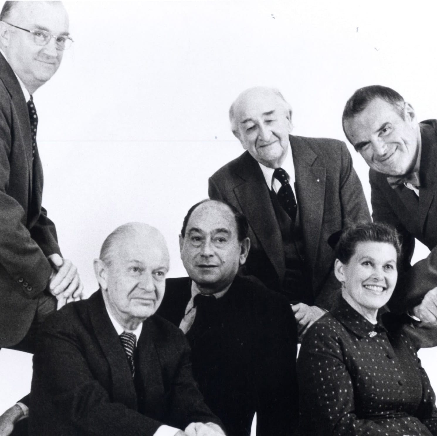 Vintage Herman Miller group photo. Black and white image of company leaders in suits and dresses. Archival business history.
