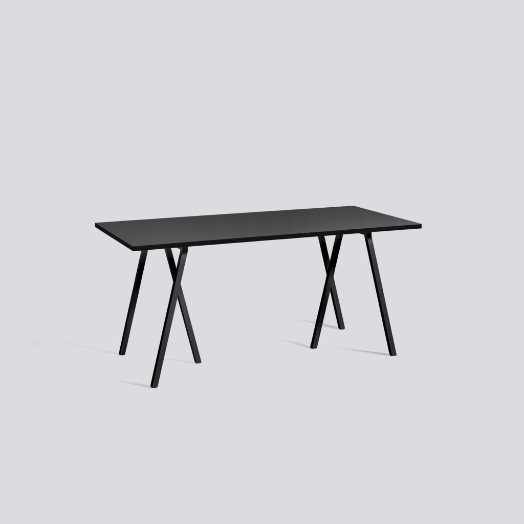 A black rectangular desk with a flat top and angled legs forming an X-shaped base.