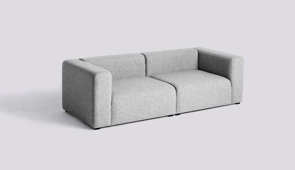 A light grey two-seat sofa with square armrests and a seam down the middle, set against a plain background.