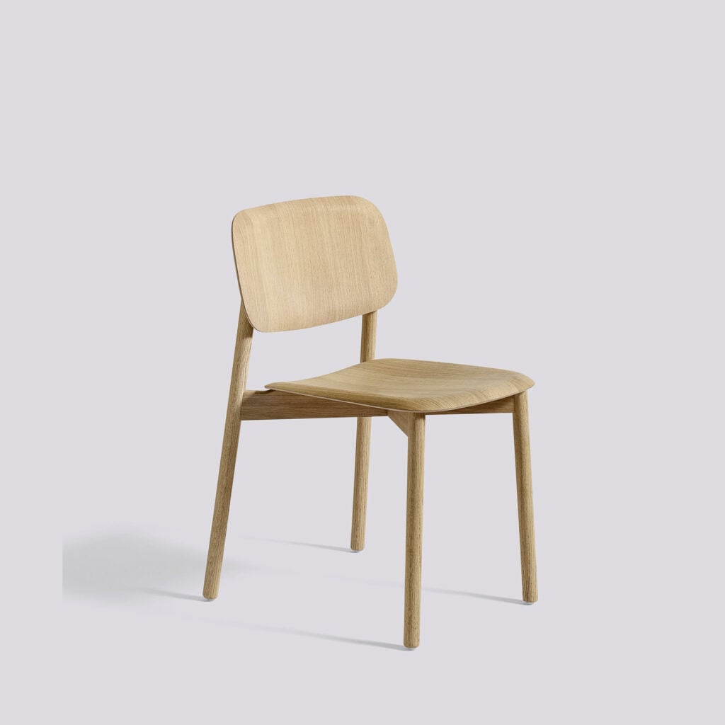 A light oak chair with a gently curved backrest and contoured seat, supported by four straight wooden legs.