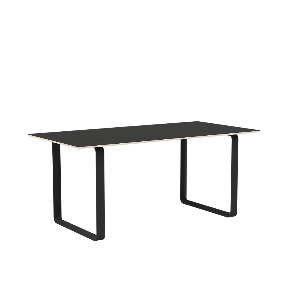 Black rectangular desk with dark metal legs and side panels, shown against a black background.